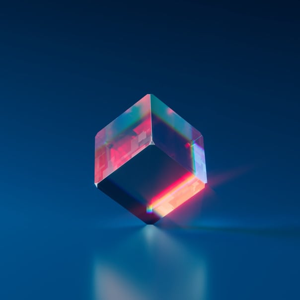 A semi-transparent blue cube with various red glows and its reflection on the floor.